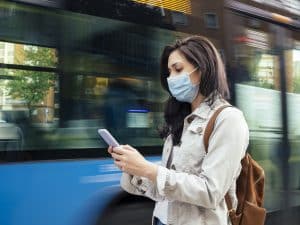 Femme avec un masque qui attend le bus septembre Ariège