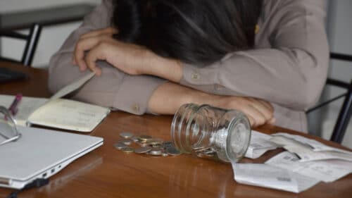 Une femme devant quelques pièces de monnaie.