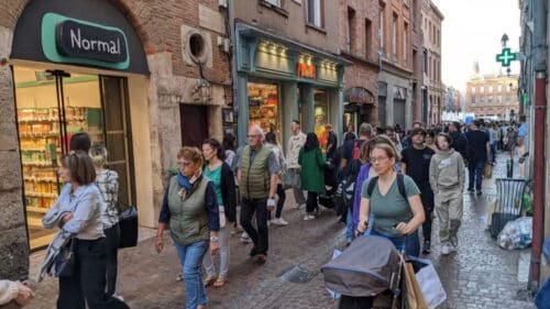 Des passants dans une rue commerçante de Toulouse.